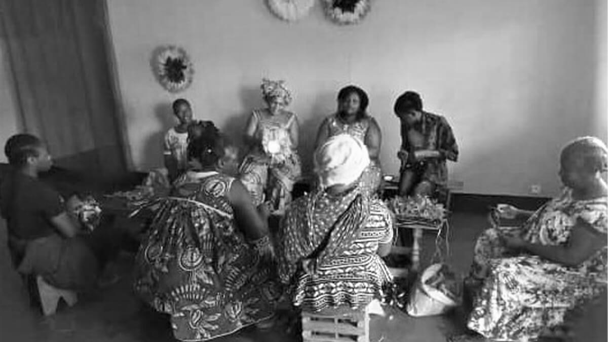 African artisans creating baskets, which will be sold at the Luangisa African Gallery.