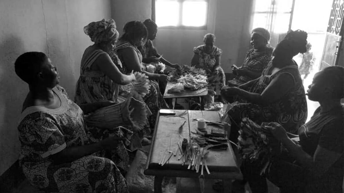 African artisans creating baskets, which will be sold at the Luangisa African Gallery.