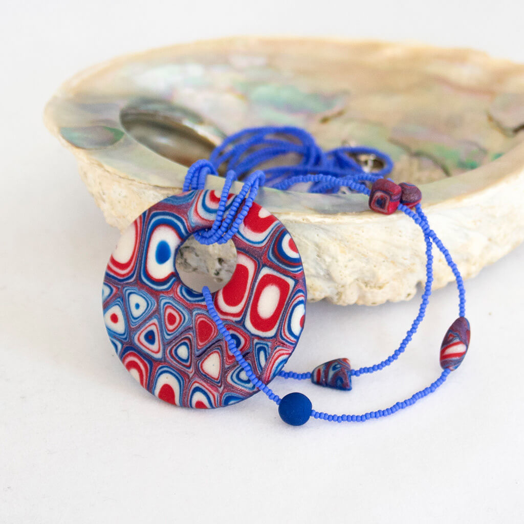 One of Yuliya Shulman's pieces of handmade jewelry in red, white and blue. Polymer clay and seed beads. 