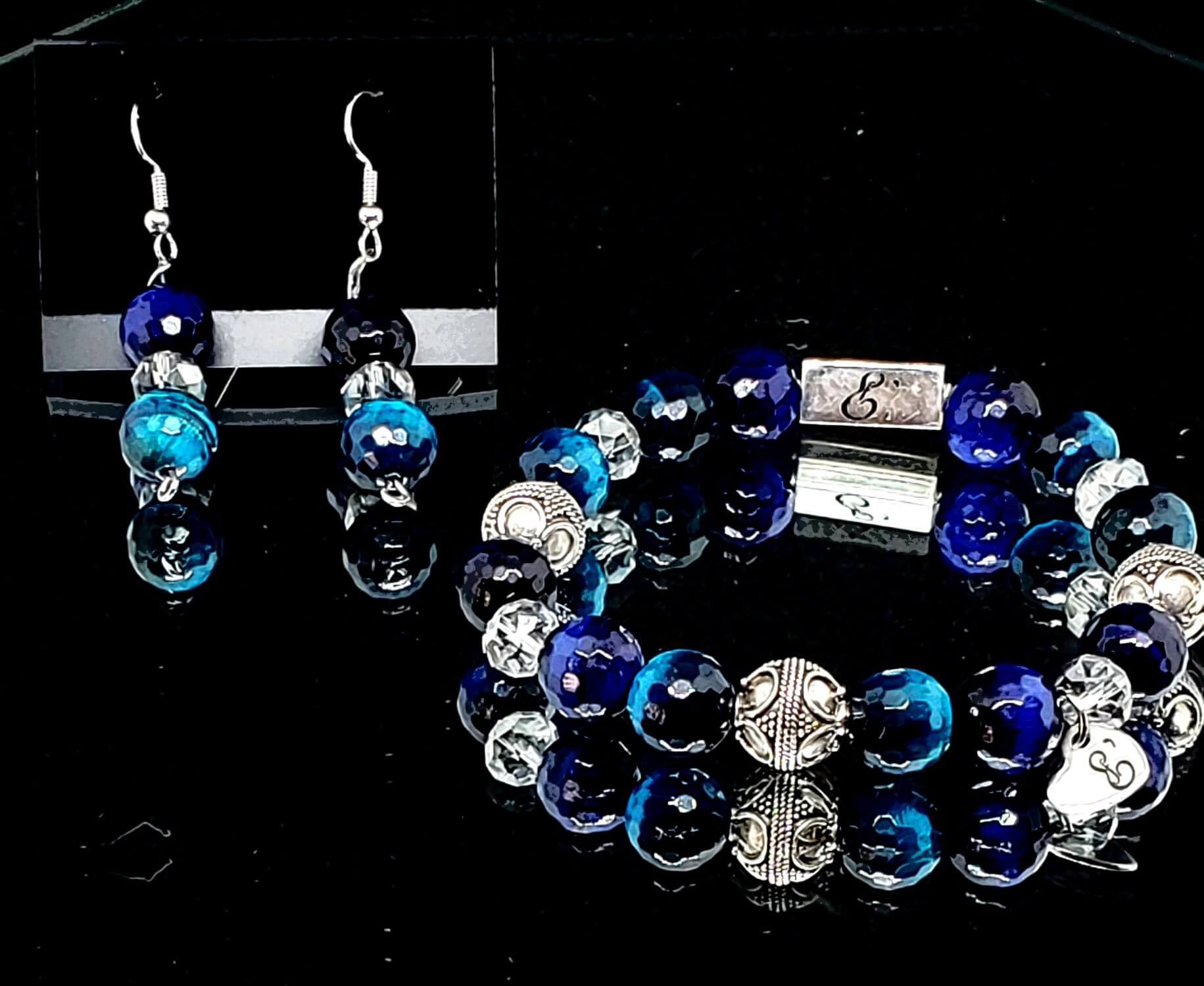 Handmade luxury beaded bracelet from E'lur Wrist Designs. The bracelet features dark blue gemstone and silver beads with silver findings.