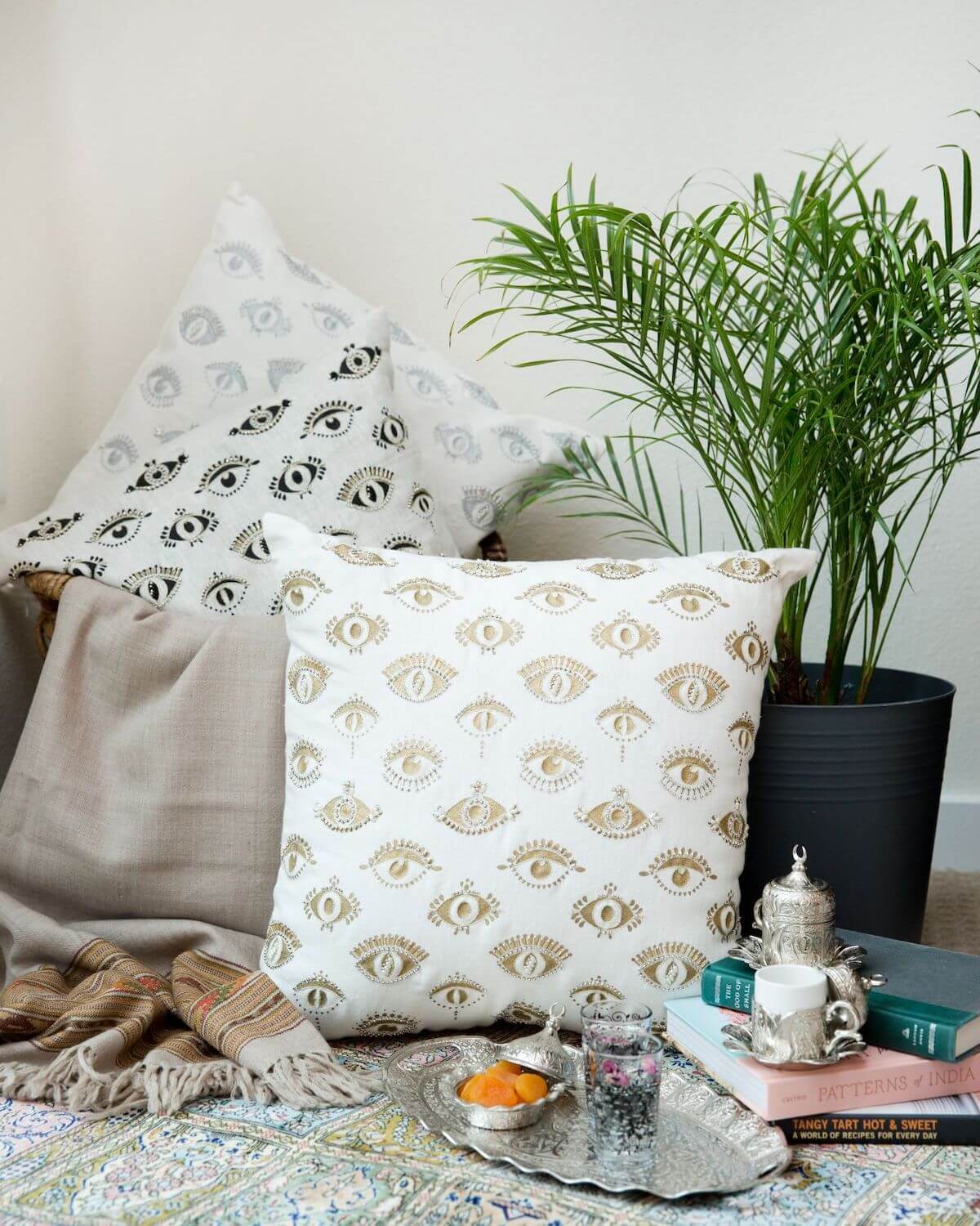 Throw pillows designed by Sushmitha Pidatala of Arjuna Design Studio. The pillows feature an evil eye design. 