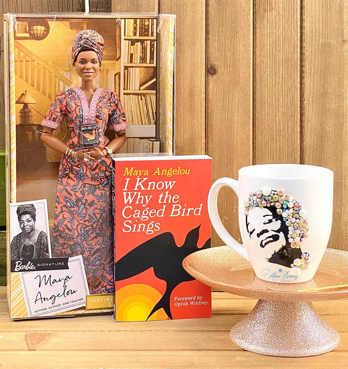 Mug by Alicia Boateng Designs. This coffee mug features the likeness of Maya Angelou accentuated with gems and beads.