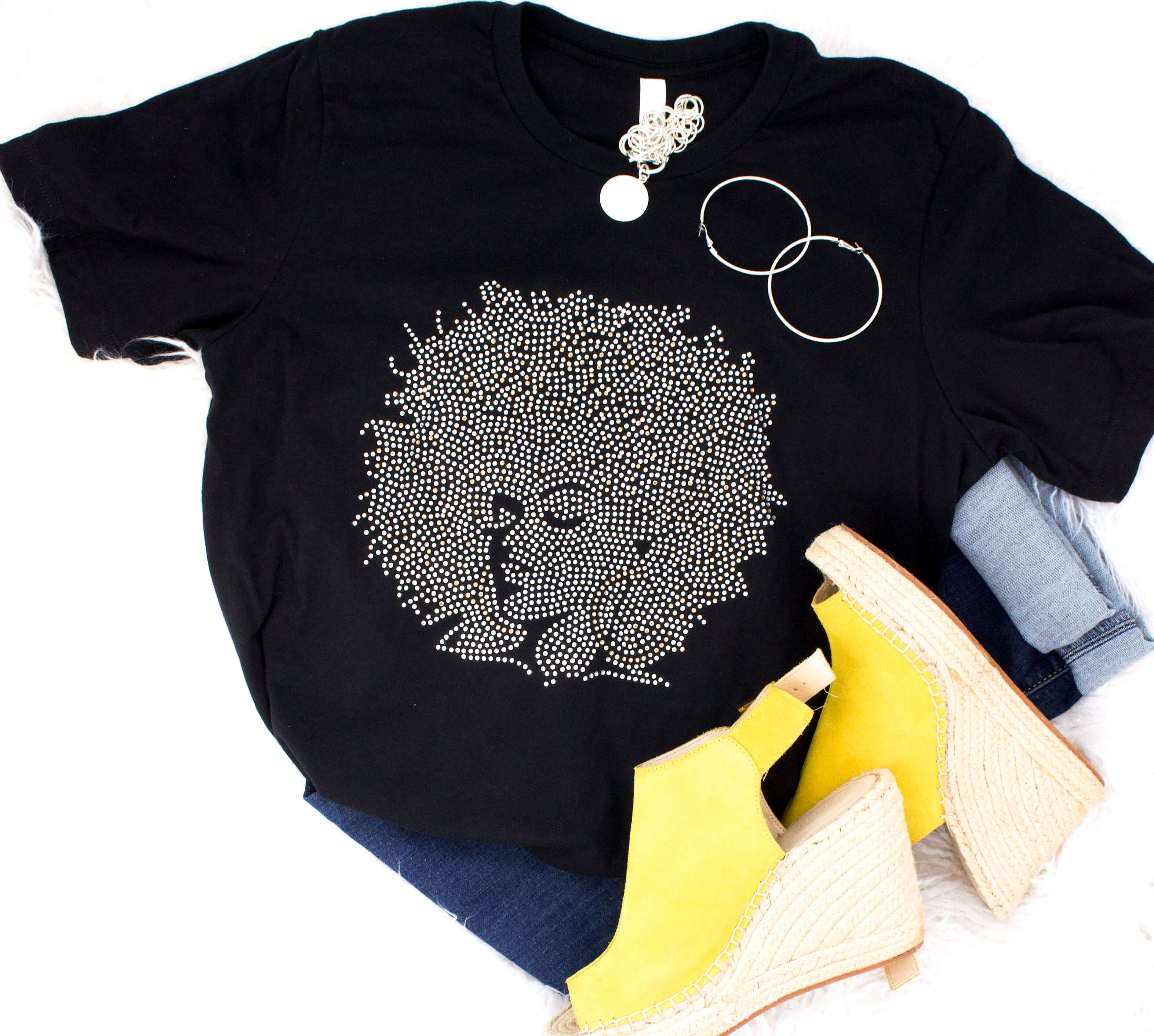 A photo of one of Lynn Woods' designs. It's a black t-shirt with the silhouette. It's called "Afro Woman."