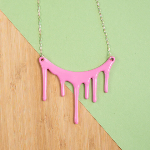 Necklace that looks like 6 paint drips in varying sizes in pink on a chain. Darling Marcelle offers unique jewelry designs.