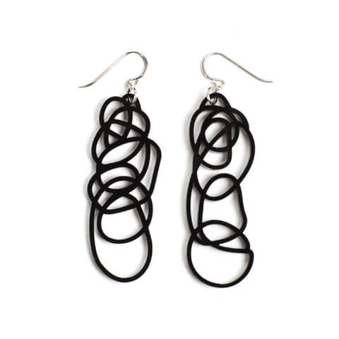 Long black earrings in an abstract shape. Darling Marcelle offers unique jewelry designs.